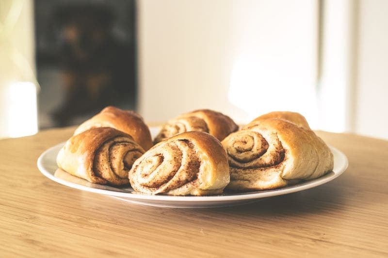 Cardamom buns cooling on a plate.