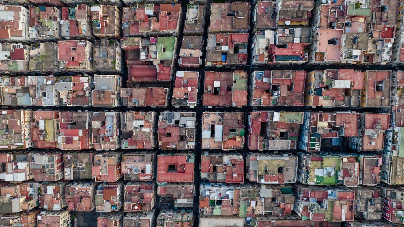 Aerial view of a dense city block grid, standing in for the streets around the cafe.